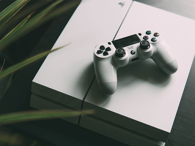 Selective focus photography of white Sony PS4